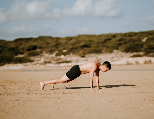 Man doing a push-up outdoors for calisthenics for beginners and bodyweight strength training.