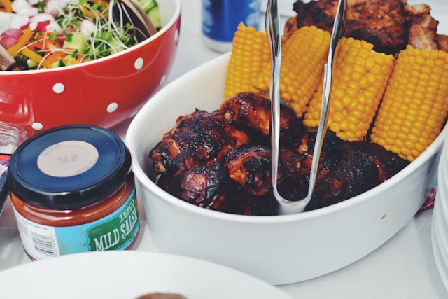 Healthy BBQ sides with grilled corn and fresh salad