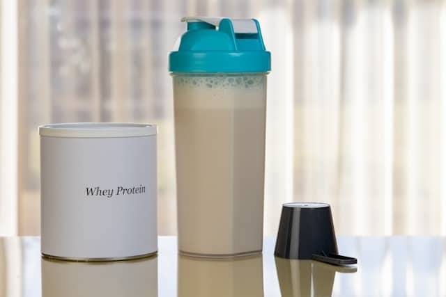 Whey protein container and shaker bottle for post-workout nutrition