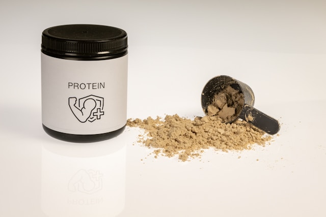 Whey Protein powder container with scoop, chocolate flavor supplement
