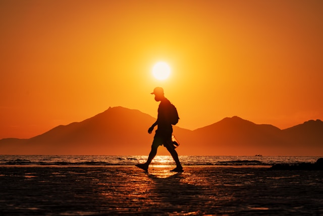 Person walking in sunlight for mitochondrial energy, recovery, and fatigue support.