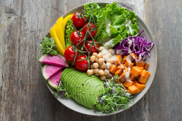 Healthy balanced plate with vegetables, avocado, chickpeas, and whole foods for nutrition after 40.