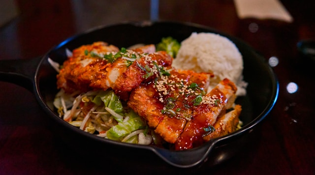Salmon, rice, and vegetables as a high-protein meal for protein for muscle growth.