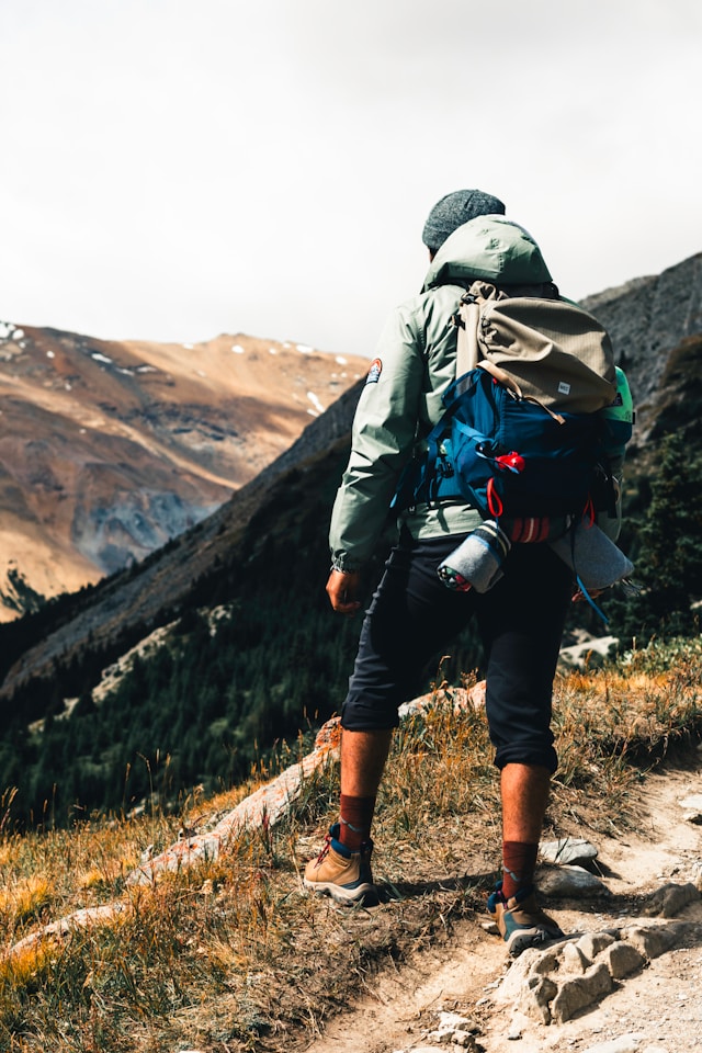 Person rucking outdoors to improve VO2 max after 40 with low-impact zone 2 cardio.