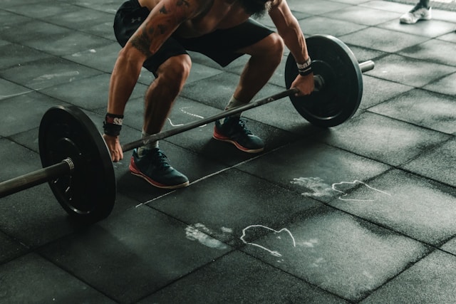 Adult performing strength training in a gym