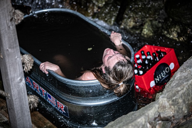 Woman using a cold plunge for post-workout recovery