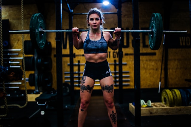 Woman lifting a barbell during strength training